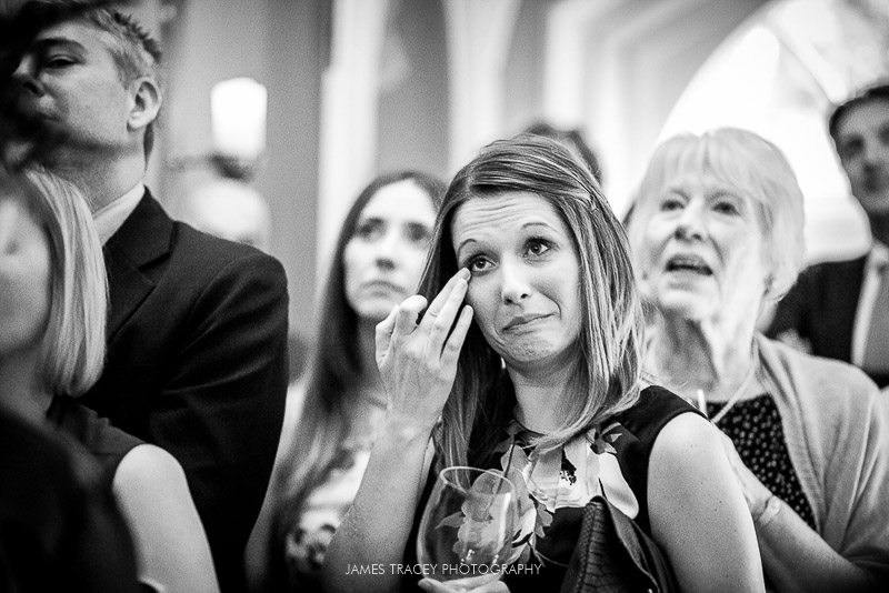 wedding guest wiping a tear away