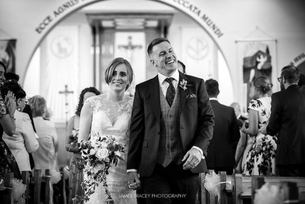 bride and groom walking out of church