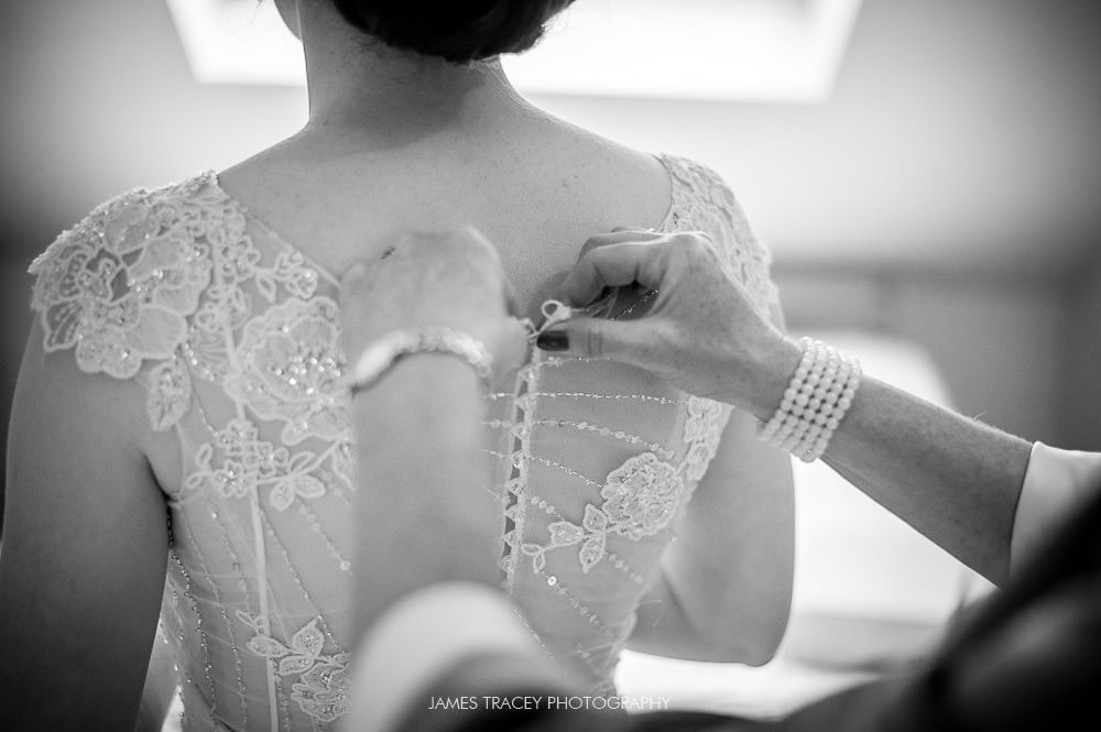 bride getting in her wedding dress