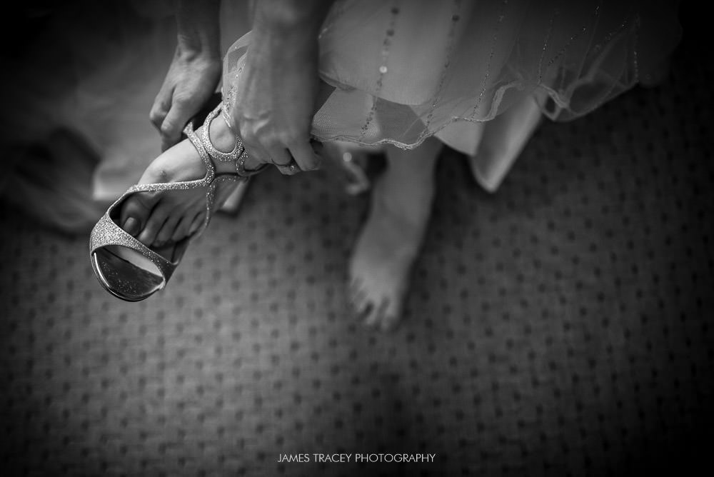 bride putting her shoes on