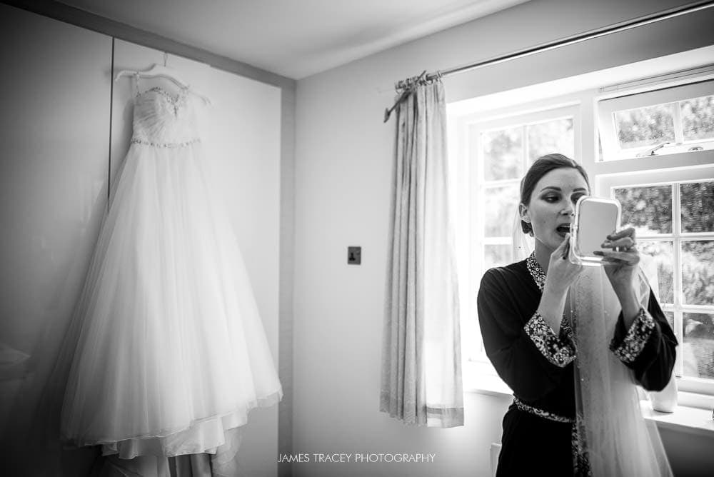 bride getting ready with dress in background