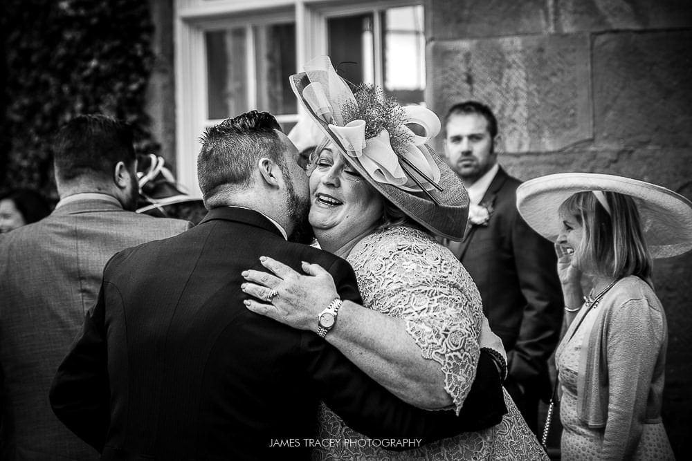 grooms mum hugging guest