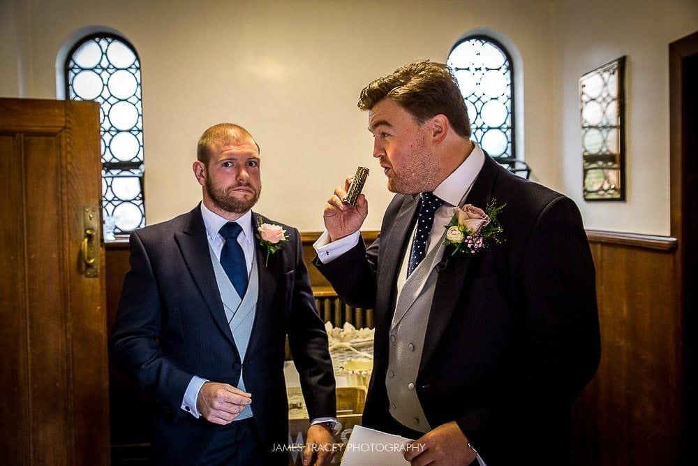 groom having drink from hip flask