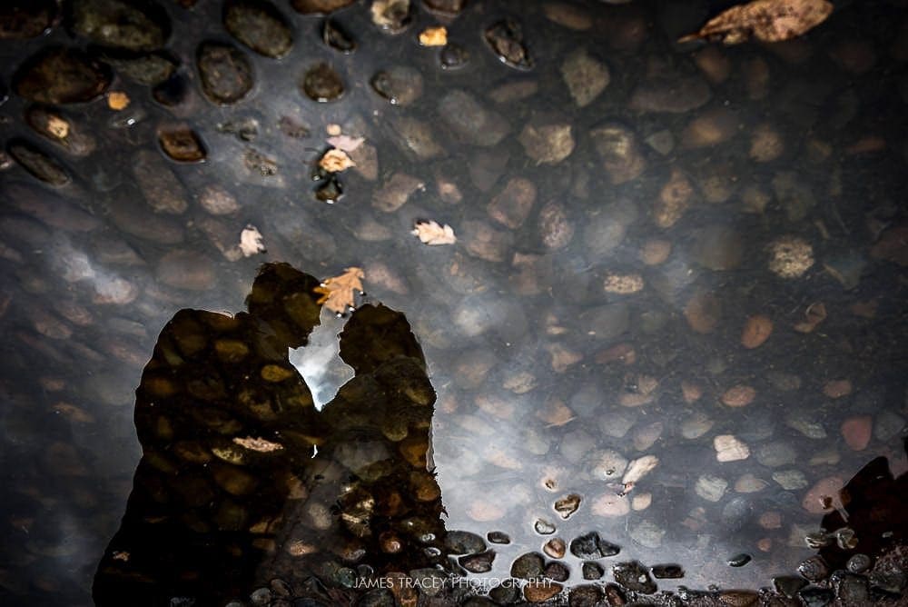 bride and groom reflected in a puddle