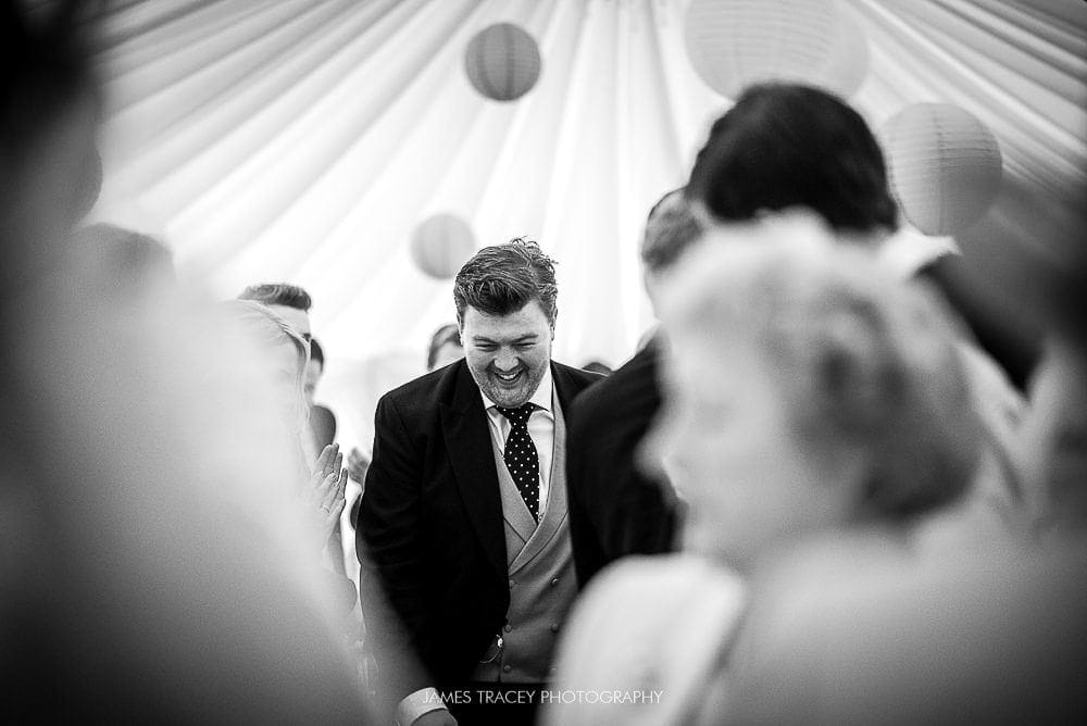 groom walking into reception