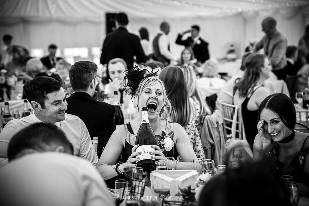 wedding guest with champagne bottle