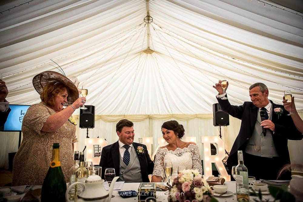 father of the bride toasting couple