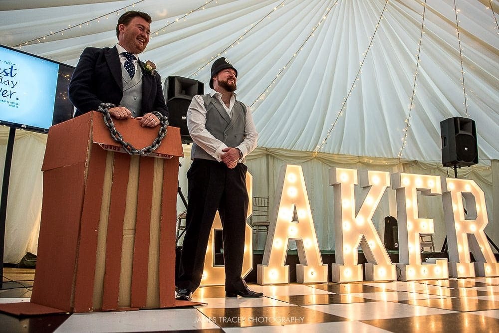 groom in the dock in front of light up letters