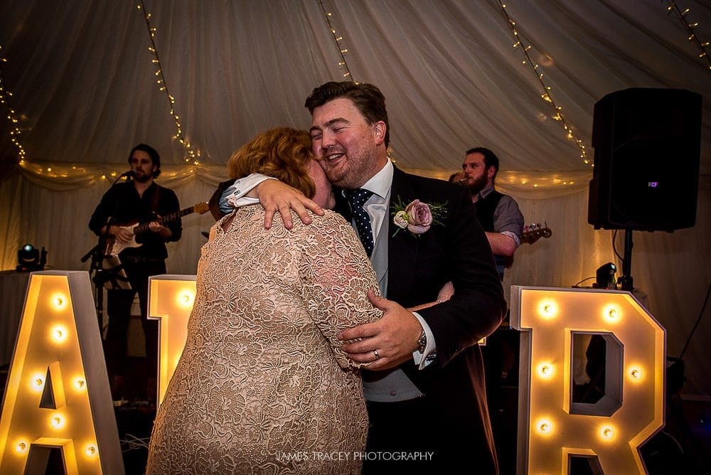 groom hugging his mum on dancefloor