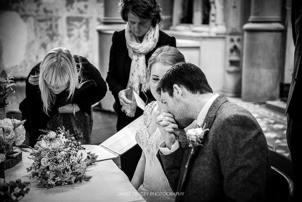 groom kissing brides hand