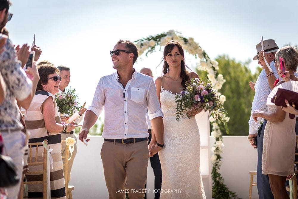 bride and groom walking back down the aisle in ibiza