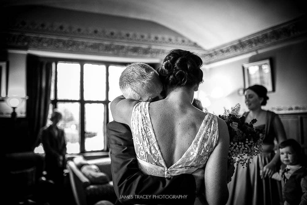 father of the bride hugging daughter