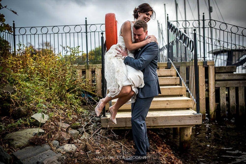 groom helping bride jump down stairs