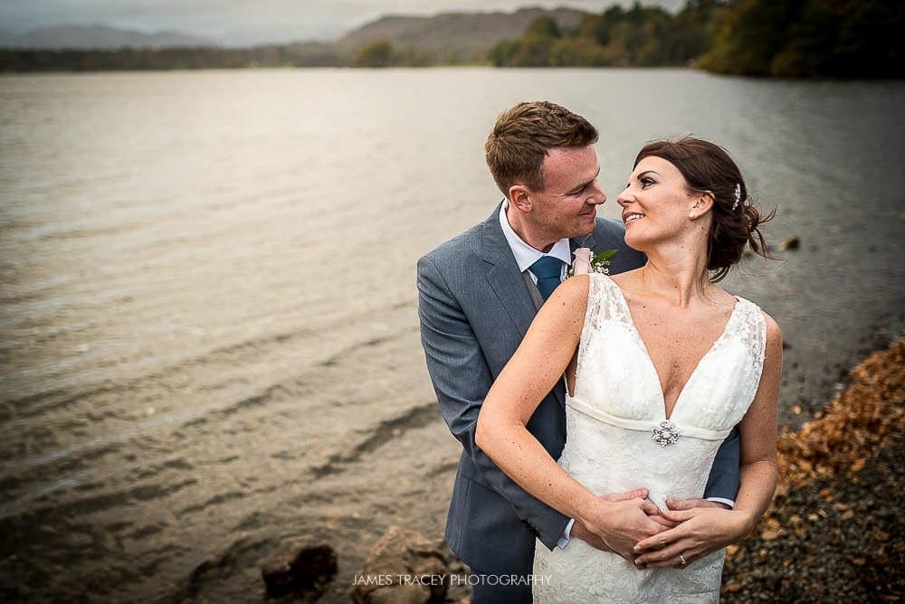 bride and groom in front of lake windermere