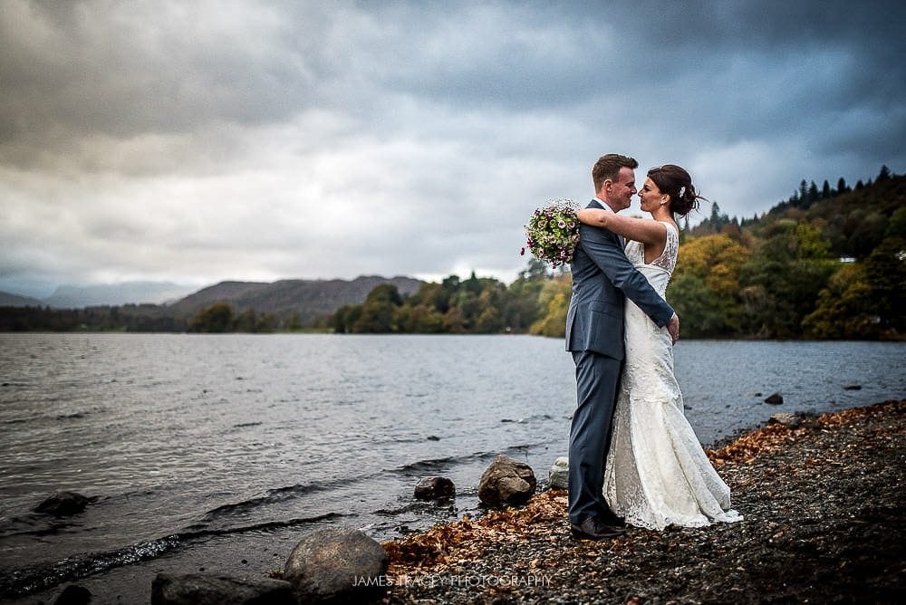 bride and groom in front of lake windermere