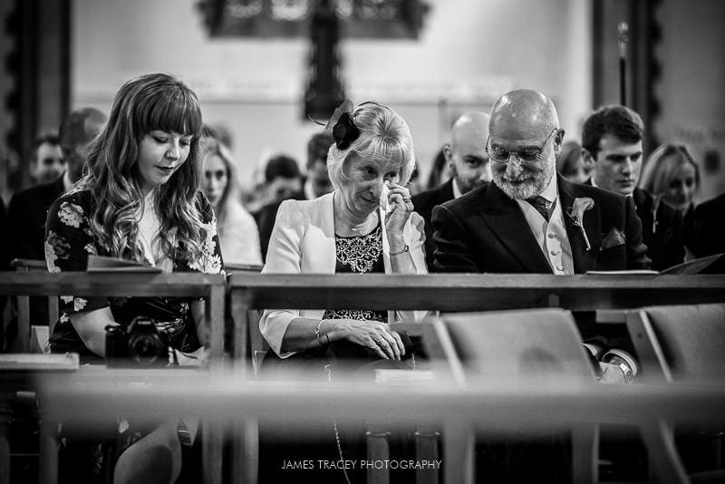 wedding guest wiping tears from her eyes