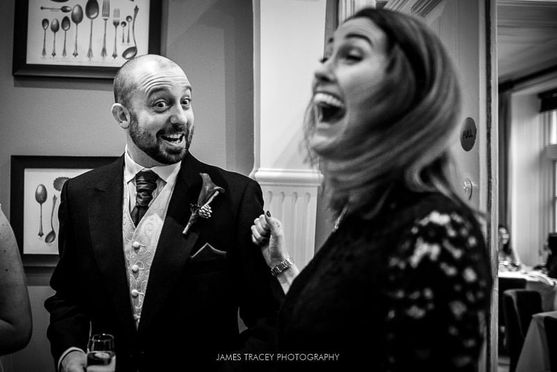 groom laughing with a wedding guest at woodlands hotel leeds