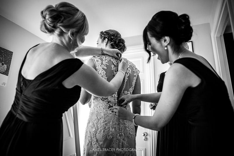 bride getting in her wedding dress