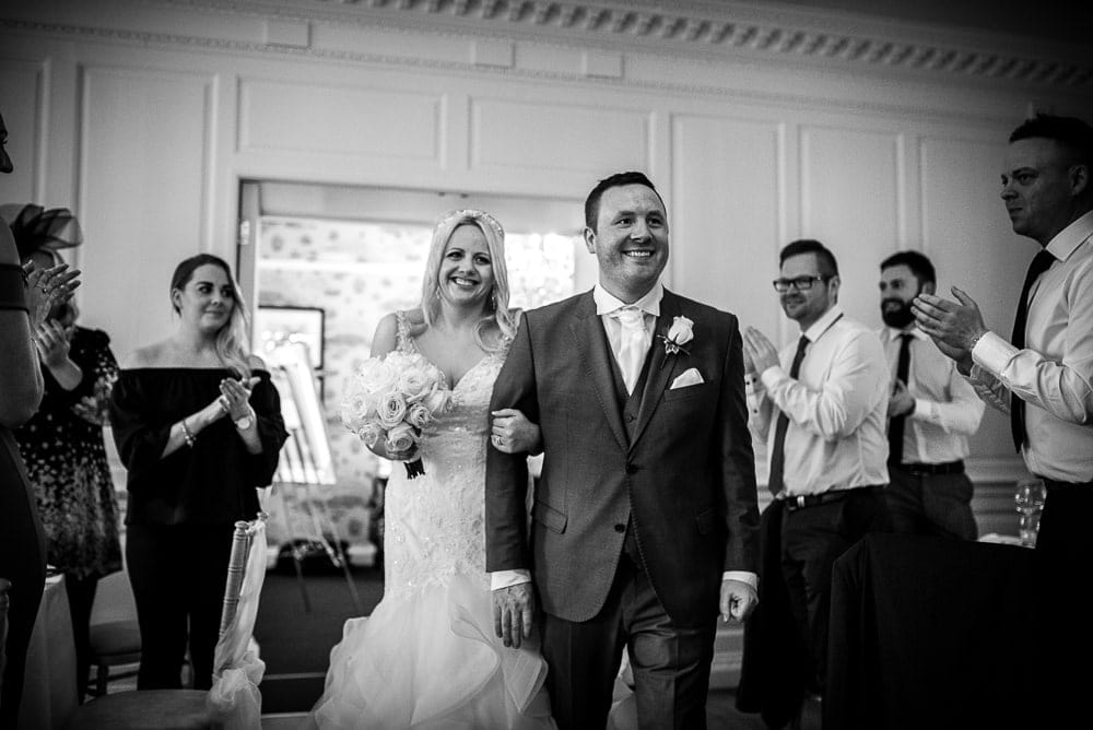 wedding couple walking into wedding breakfast