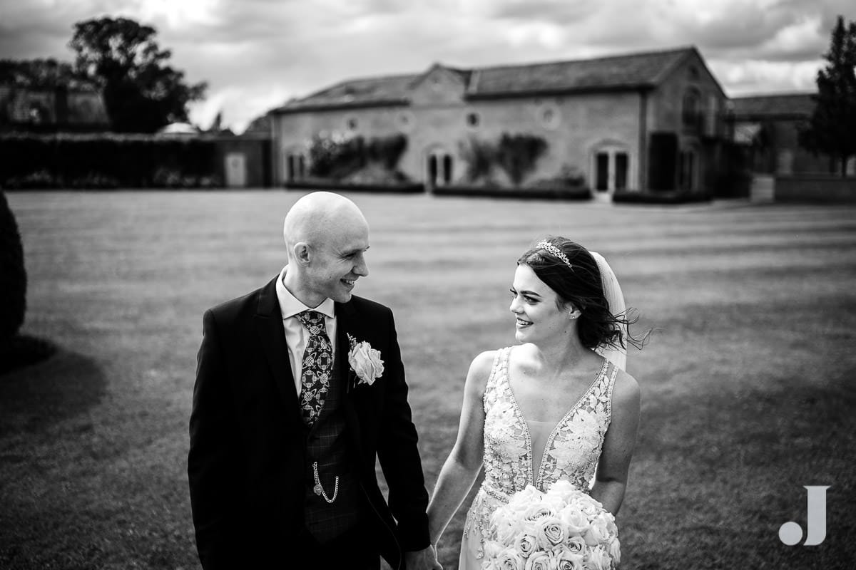 bride and groom walking in front of merrydale manor