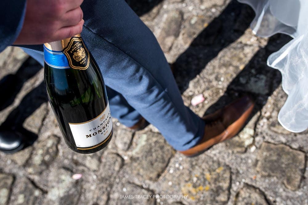 wedding guest holding bottle of champage