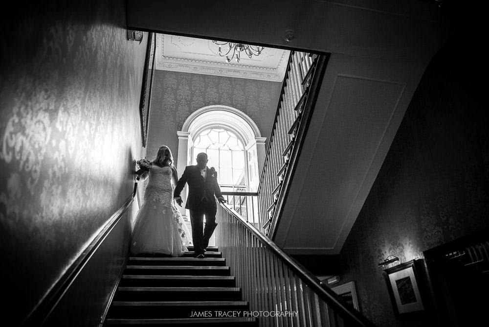 bride walking to her wedding at mottram hall