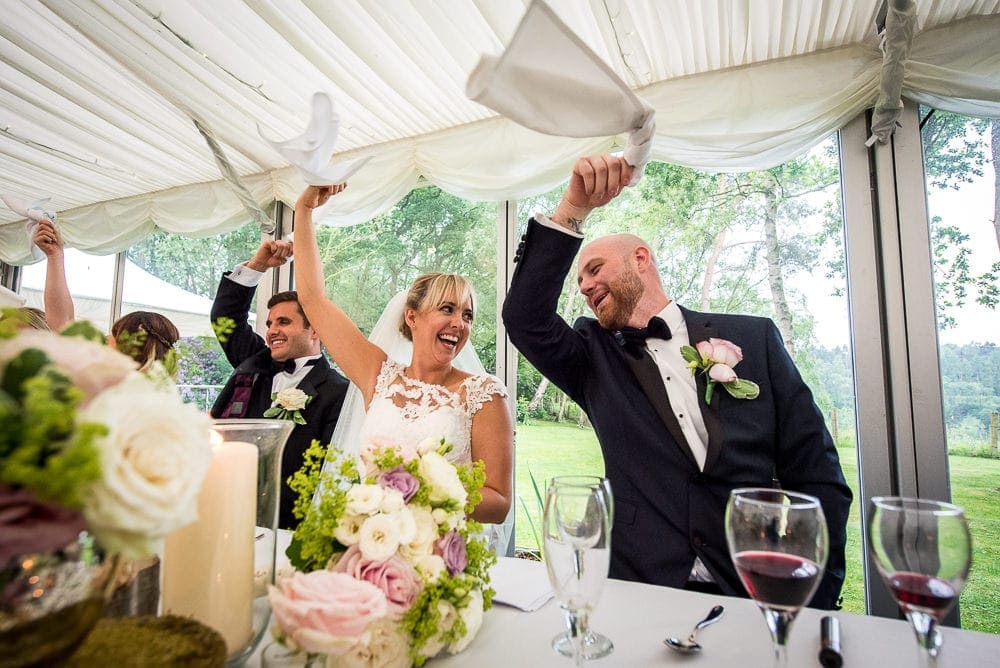 bride and groom enjoying singing waiters