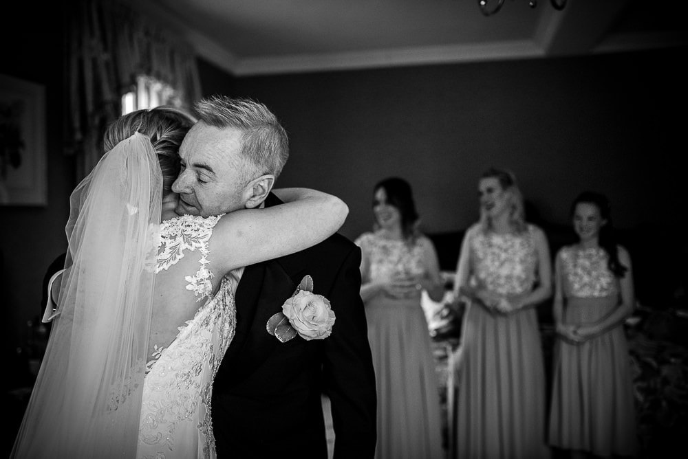 father of the bride hugging daughter