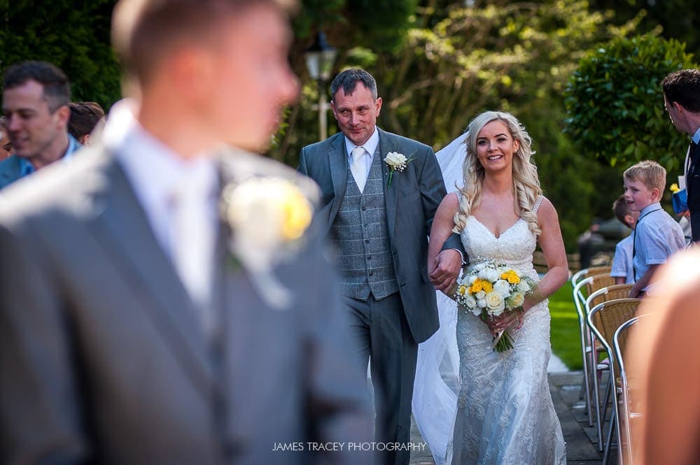 bride arriving at her outdoor wedding at the saddleworth hotel