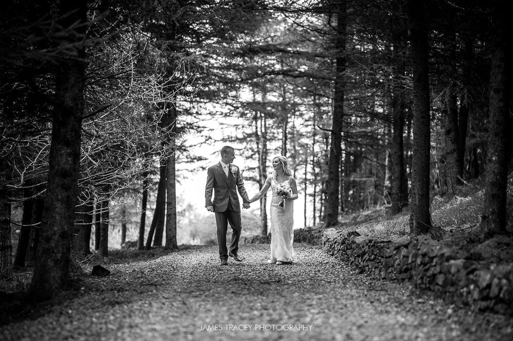 bride and groom walking in woods