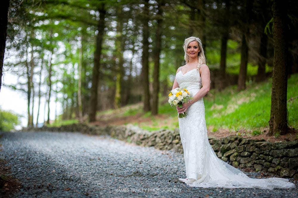 bride posing at her outdoor wedding at saddleworth hotel