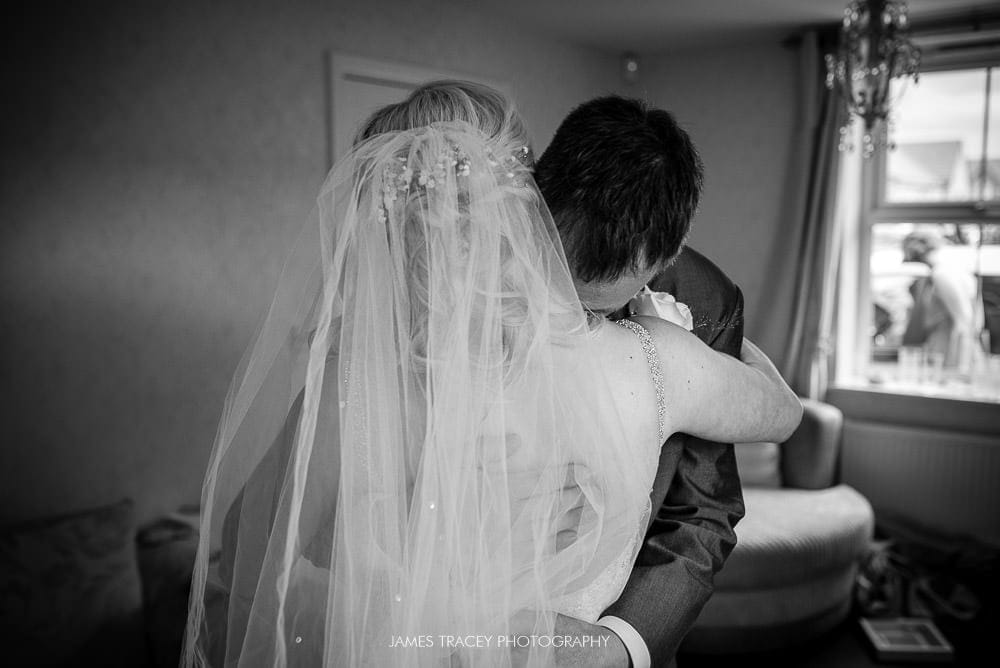 father of the bride hugging daughter