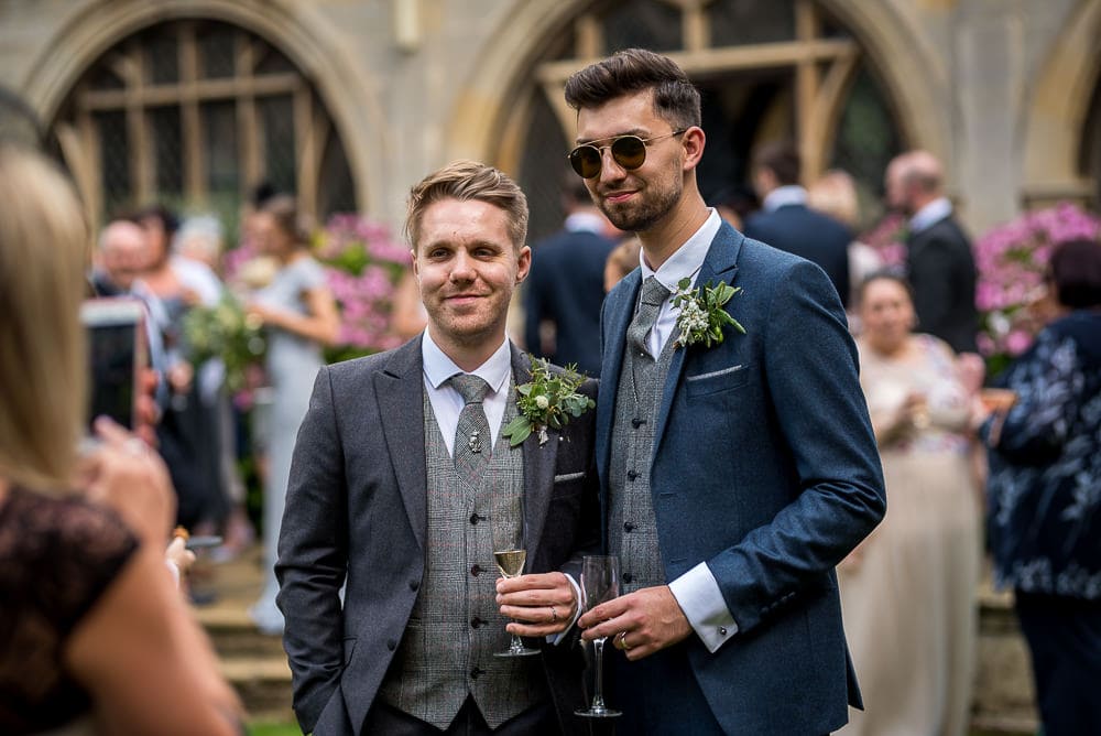 same sex couple pose for photos at rushton hall wedding