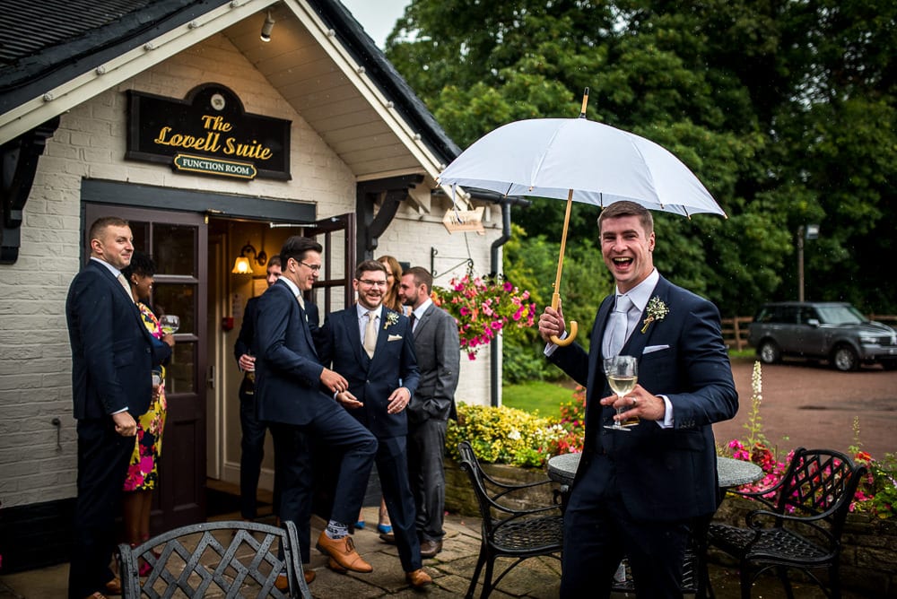 groom with umbrella at swettenham arms