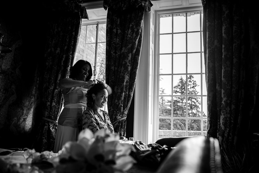 bride in window getting ready