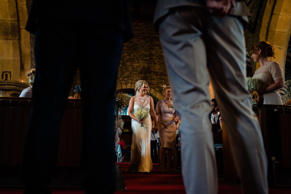 low angle of bride walking up the aisle