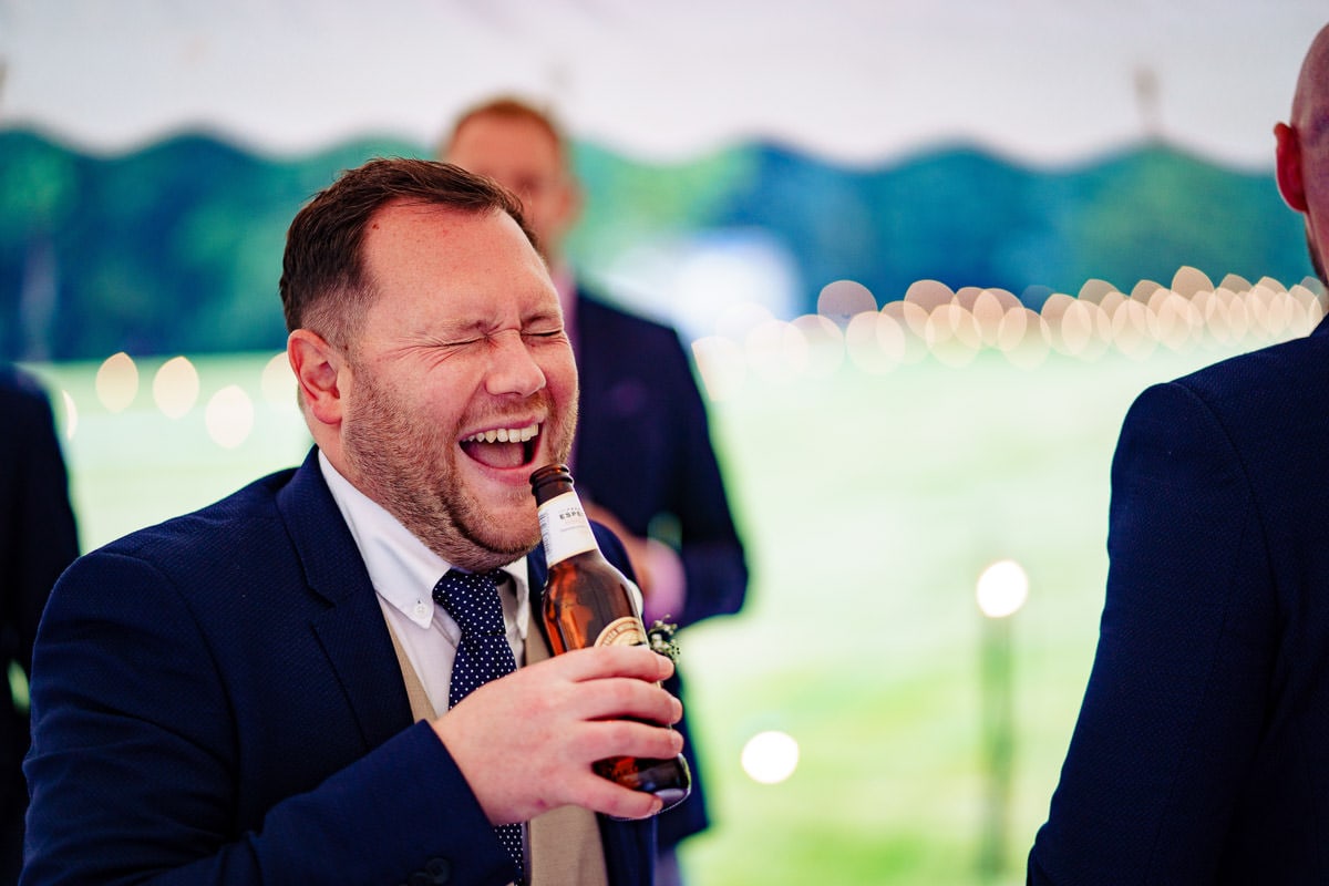 laughing wedding guests