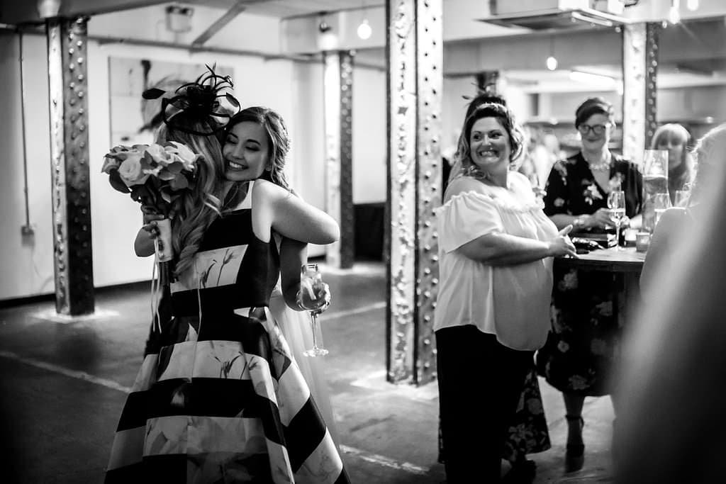 guests hugging couple at victoria warehouse wedding