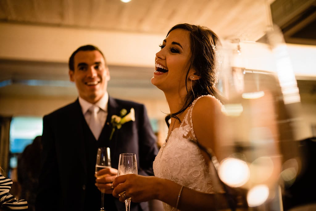 bride laughing in front of her new husband