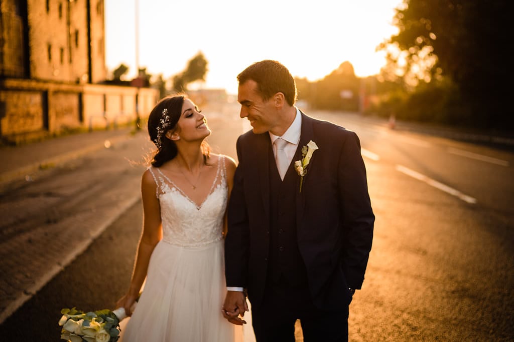 bride and groom walking in the golden house in manchester