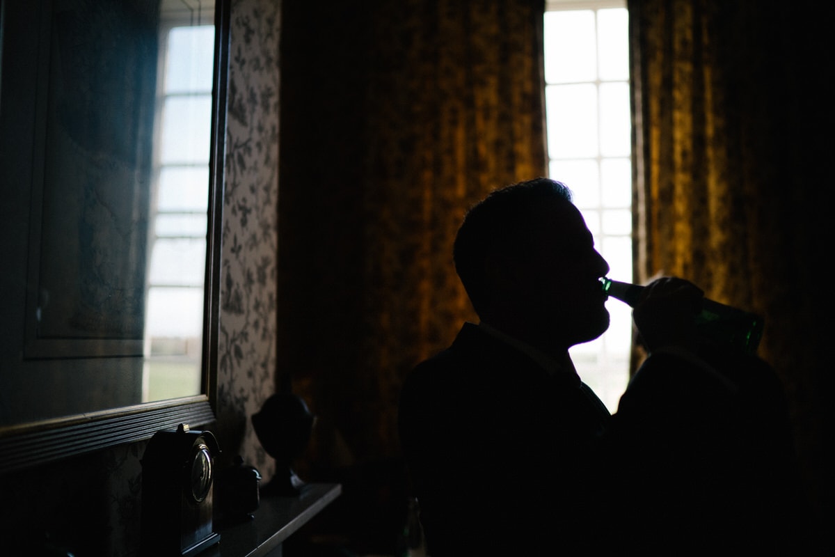 groom having a beer at his wedding