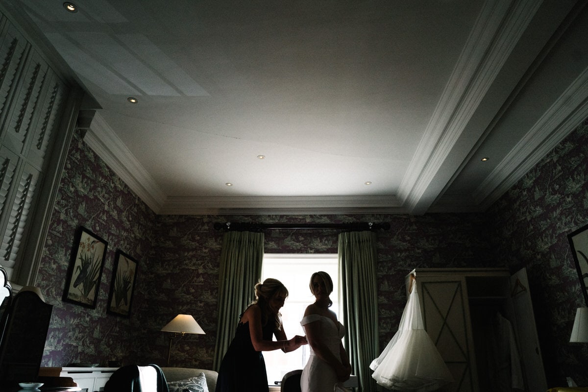 bride getting in her dress at knowsley hall