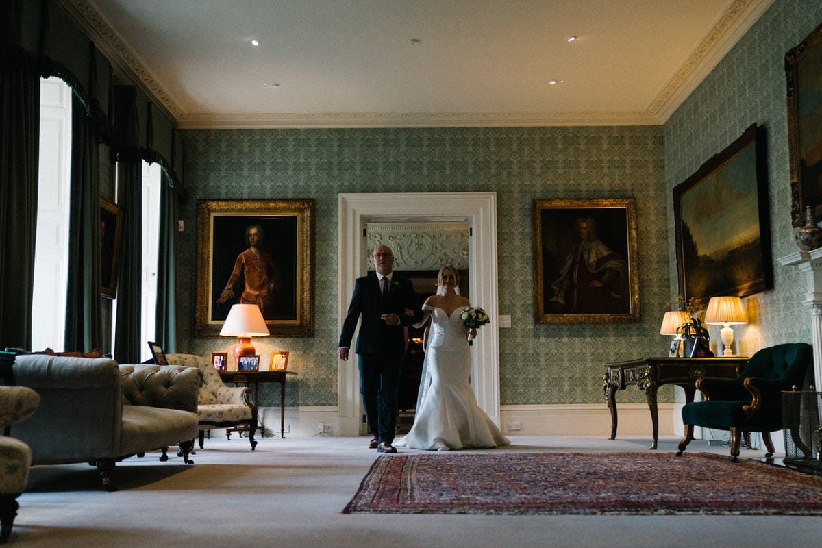 bride and her father walking through knowsley hall