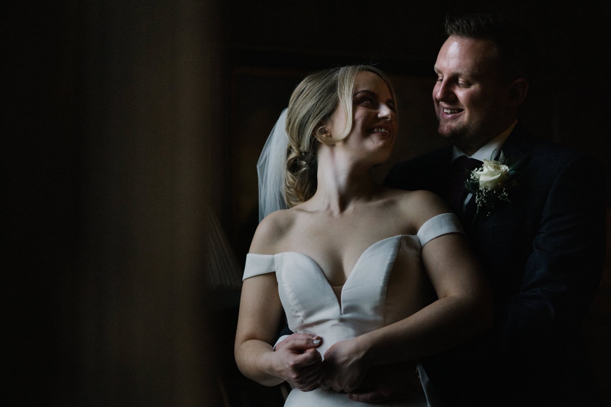 bride and groom in window light at knowsley hall