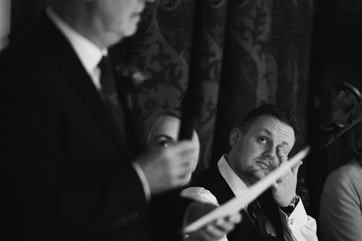 groom wiping tear from his eye