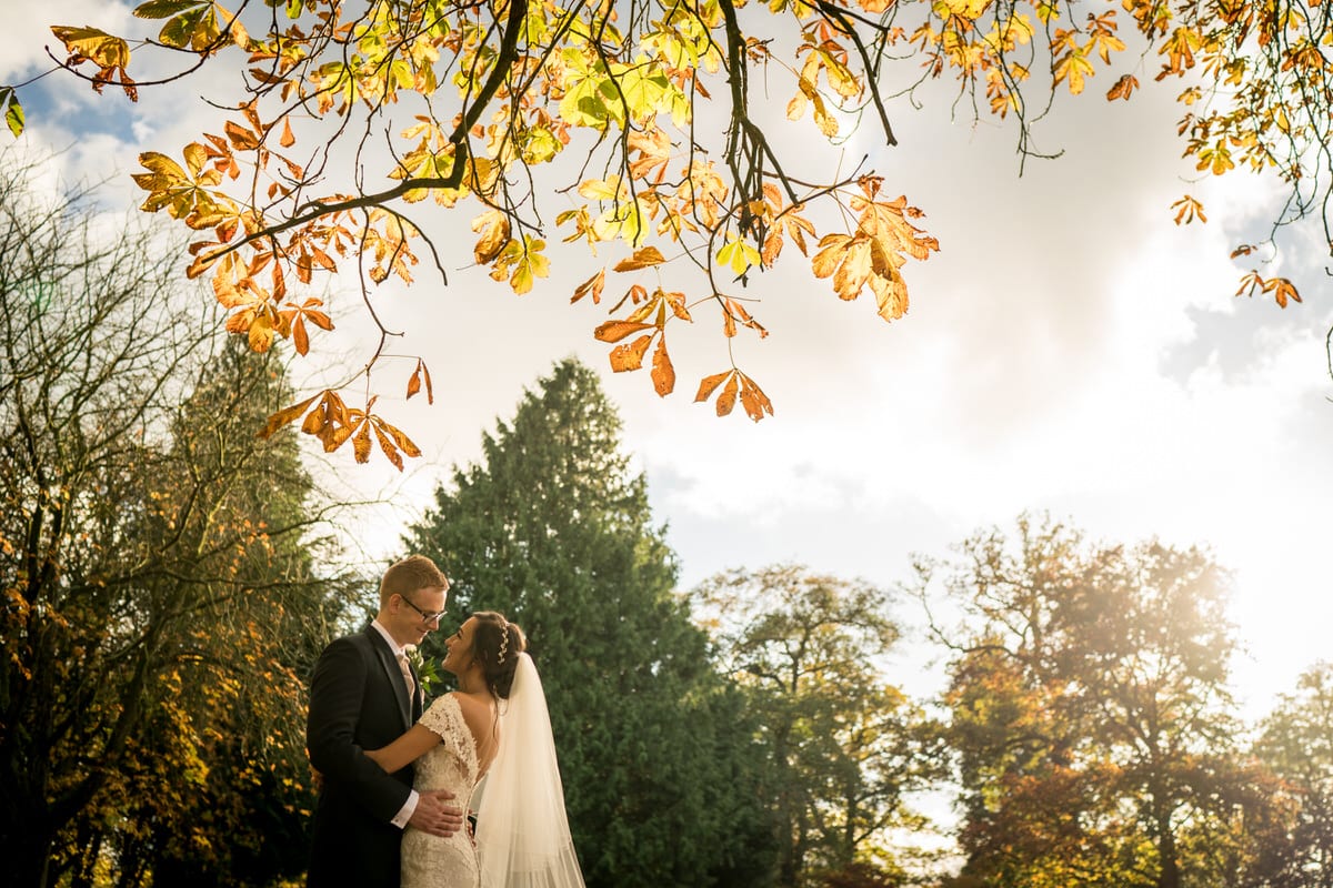 bride and groom in autumnal colours at colshaw hall