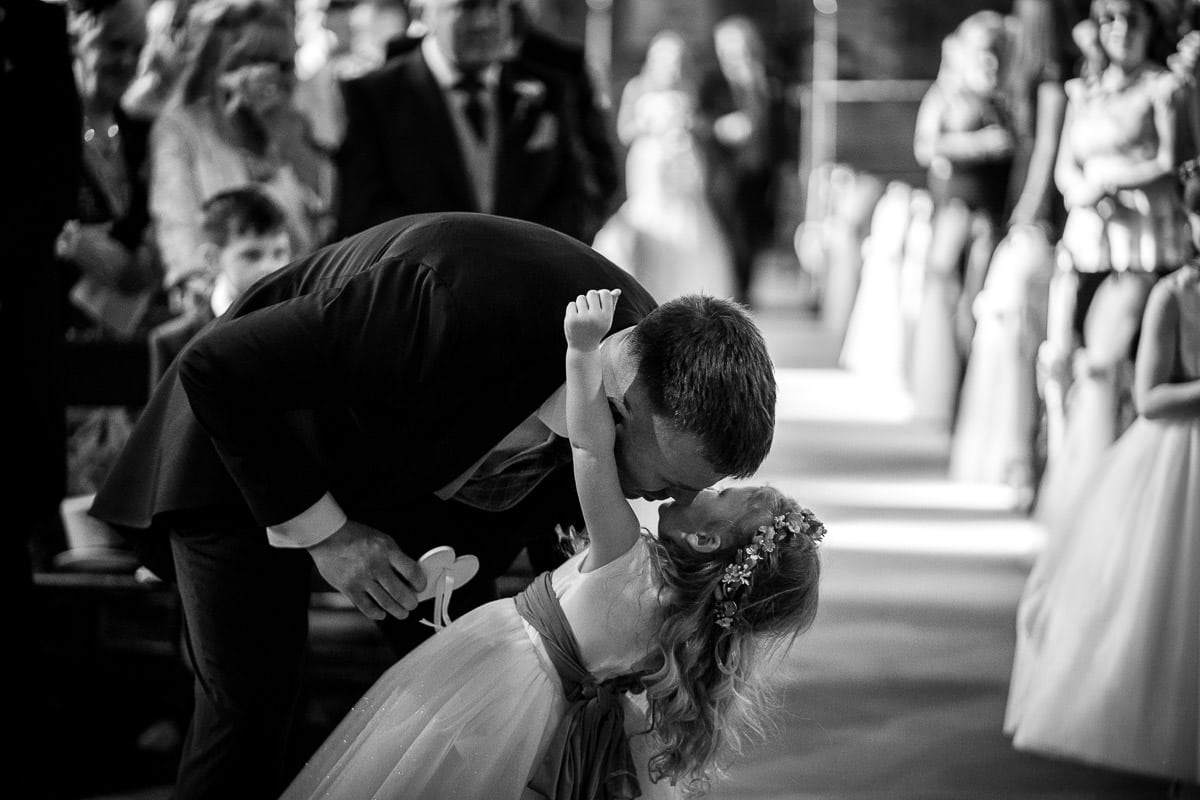 groom kissing his daughter at wedding