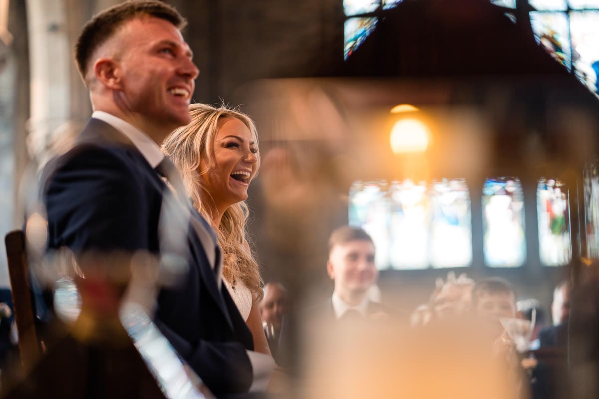 laughing bride during fun wedding service