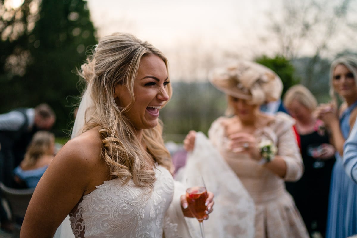 bride laughing at drinks reception