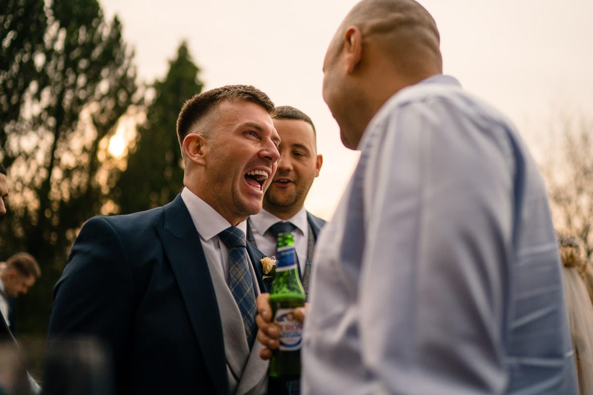 groom luaghing at mitton hall wedding